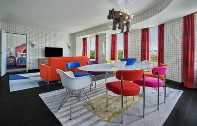 a dining room with a table and colorful chairs at Graduate by Hilton Cincinnati in Cincinnati