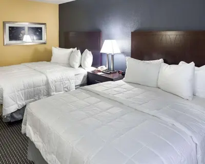 a hotel room with two beds and a telephone at Quality Inn Montpelier in Montpelier