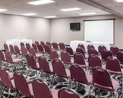 a conference room with rows of chairs and a screen at Quality Inn Montpelier in Montpelier