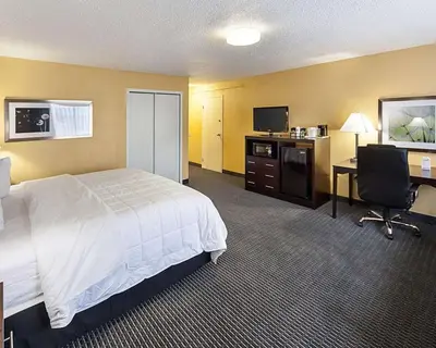 a hotel room with a bed and a desk at Quality Inn Montpelier in Montpelier