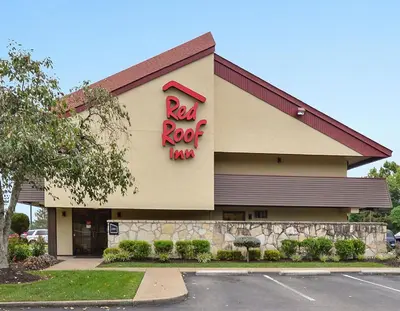 a red rock inn sign on the side of a building at Red Roof Inn Huntington in Barboursville
