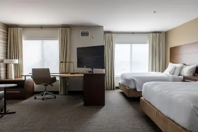 a hotel room with two beds and a flat screen tv at Residence Inn by Marriott Toledo West in Toledo