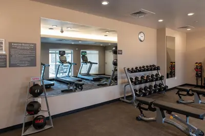 a fitness room with a mirror and weights at Residence Inn by Marriott Toledo West in Toledo