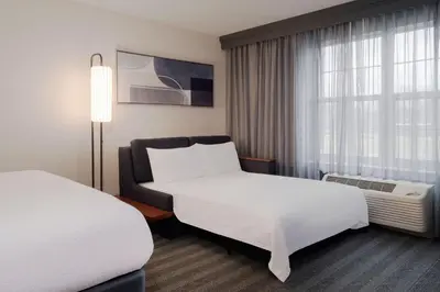 a hotel room with two beds and a window at Courtyard by Marriott Columbus New Albany in New Albany