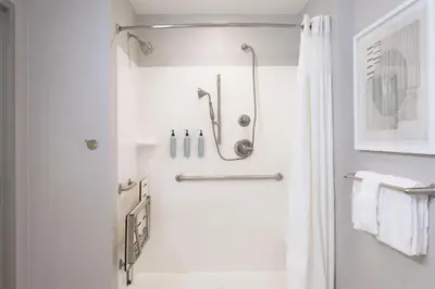 a white bathroom with a shower and a toilet at Courtyard by Marriott Columbus New Albany in New Albany