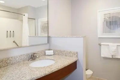 a bathroom with a sink and a mirror at Courtyard by Marriott Columbus New Albany in New Albany