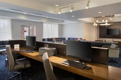 an office with a desk with two monitors and chairs at Courtyard by Marriott Columbus New Albany in New Albany