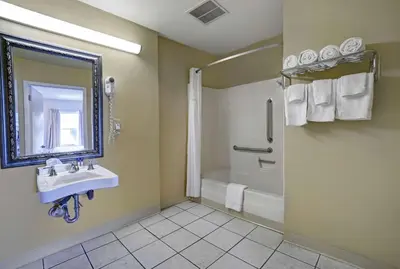 a bathroom with a shower and a sink and a tub at Motel 6 Washington, PA in Washington