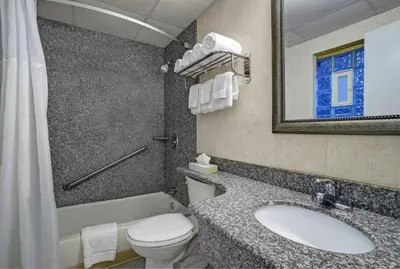 a bathroom with a sink and a toilet and a mirror at Motel 6 Washington, PA in Washington