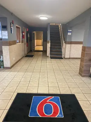 a hallway with a floor mat with the number on it at Motel 6 Hurricane, WV in Hurricane