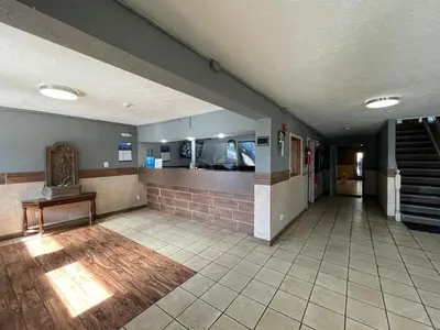 an empty hallway with a staircase in a building at Studio 6 Suites Hurricane, WV in Hurricane