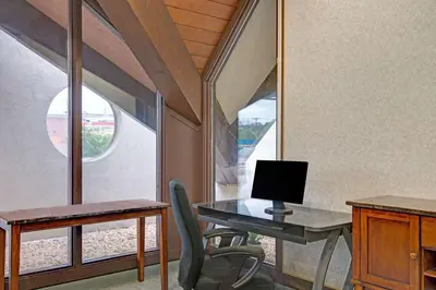 an office with a desk with a computer and a chair at Days Inn by Wyndham Washington in Washington