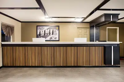 a hotel lobby with a reception desk with a counter at Travel Inn Of Sidney Ohio in Sidney