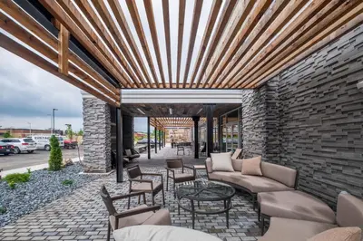a patio with a couch and chairs and a table at Courtyard by Marriott Toledo West in Toledo