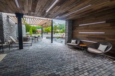 a patio with chairs and tables in a building at Courtyard by Marriott Toledo West in Toledo
