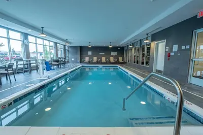a large swimming pool in a building at Courtyard by Marriott Toledo West in Toledo