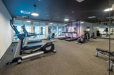 a gym with treadmills and cardio equipment in a building at Courtyard by Marriott Toledo West in Toledo