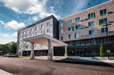 a hotel building with a large building at Courtyard by Marriott Toledo West in Toledo
