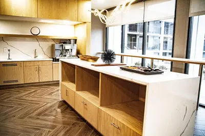 a kitchen with wooden cabinets and a white counter top at Delta Hotels by Marriott Cincinnati Sharonville in Sharonville