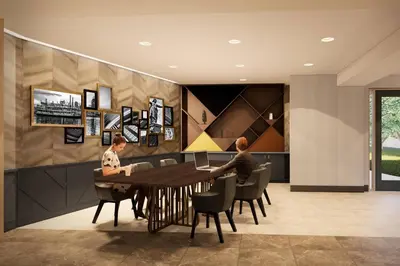 two people sitting at a table in a room at Delta Hotels by Marriott Cincinnati Sharonville in Sharonville