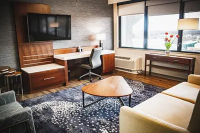 a hotel room with a desk and a couch at Delta Hotels by Marriott Cincinnati Sharonville in Sharonville