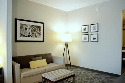 a living room with a couch and a lamp at Country Inn & Suites by Radisson, Port Clinton, OH in Port Clinton