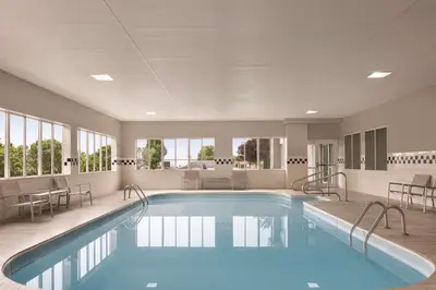 a large swimming pool with chairs and a table at Country Inn & Suites by Radisson, Port Clinton, OH in Port Clinton