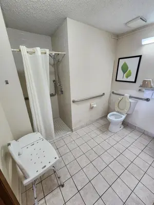 a bathroom with a shower and a toilet at WestSpring Inn - Westlake Cleveland in Westlake