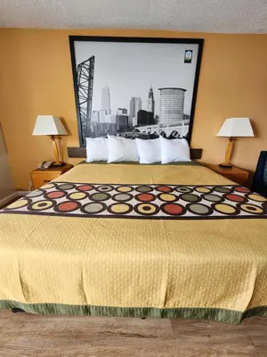 a hotel room with a bed with a large window at WestSpring Inn - Westlake Cleveland in Westlake