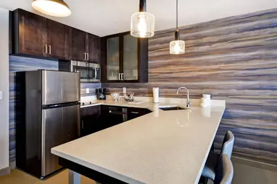 a kitchen with a refrigerator and a counter top at Residence Inn by Marriott Cincinnati Northeast/Mason in Mason