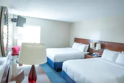 a hotel room with two beds and a lamp at Islander Inn in Put-in-Bay