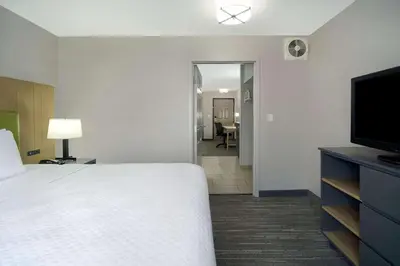 a hotel room with a bed and a flat screen tv at Country Inn & Suites by Radisson, Cincinnati Airport, KY in Hebron