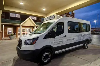 a white van parked in front of a building at Country Inn & Suites by Radisson, Cincinnati Airport, KY in Hebron