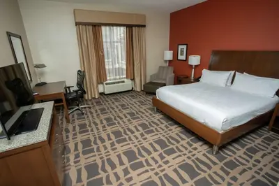 a hotel room with a bed and a television at Hilton Garden Inn Dayton South - Austin Landing in Springboro
