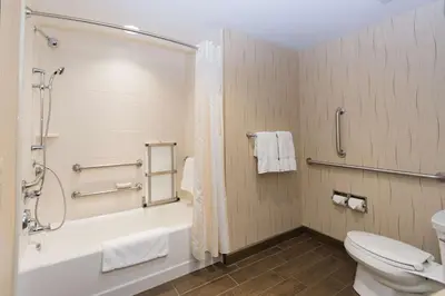 a bathroom with a tub and a toilet and a shower at Hilton Garden Inn Dayton South - Austin Landing in Springboro