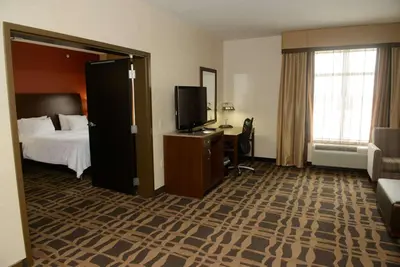 a hotel room with a bed and a television at Hilton Garden Inn Dayton South - Austin Landing in Springboro
