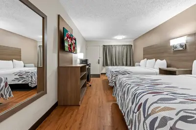 a hotel room with two beds and a television at Red Roof Inn Columbus West - Hilliard in New Rome