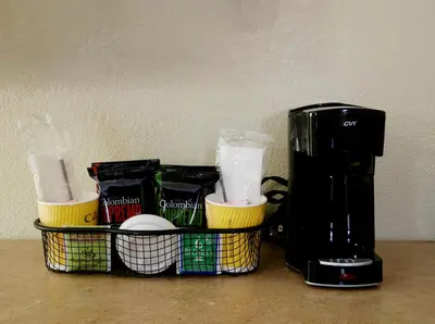 a coffee maker sitting on a counter next to a coffee pot at Red Roof Inn Columbus West - Hilliard in New Rome