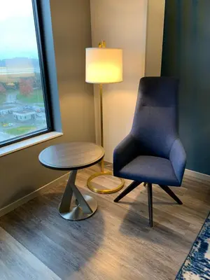 a chair and a table in a room with a window at Hyatt Regency Pittsburgh International Airport in Clinton
