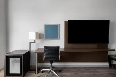 a office with a desk with a television and a chair at Hyatt Regency Pittsburgh International Airport in Clinton