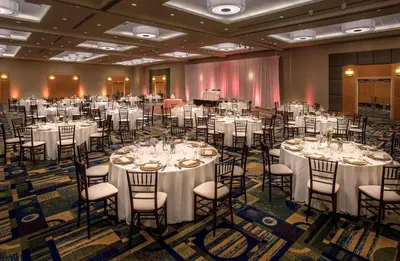 a banquet hall with white tables and chairs at Hyatt Regency Pittsburgh International Airport in Clinton