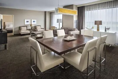 a dining room and living room with a table and chairs at Hyatt Regency Pittsburgh International Airport in Clinton