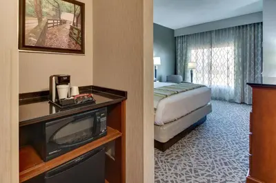 a hotel room with a bed and a television at Drury Inn & Suites Columbus Polaris in Columbus
