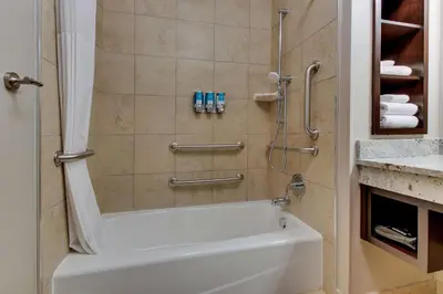 a bathroom with a white tub and a shower at Drury Inn & Suites Columbus Polaris in Columbus