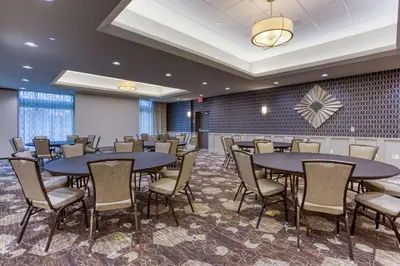 a conference room with tables and chairs and a wall at Drury Inn & Suites Columbus Polaris in Columbus