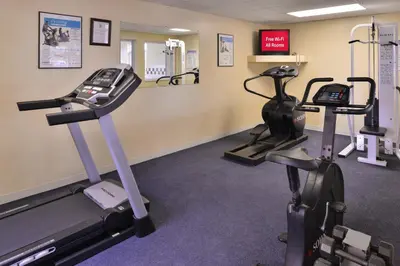 a gym with two treadmills and two exercise bikes at Red Roof Inn Clyde in Clyde