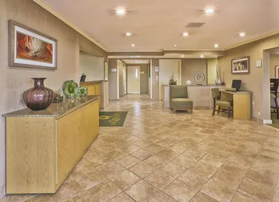 a lobby of a hospital with a counter and chairs at La Quinta Inn by Wyndham Toledo Perrysburg in Perrysburg