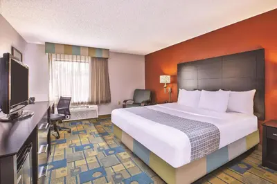 a hotel room with a bed and a television at La Quinta Inn by Wyndham Toledo Perrysburg in Perrysburg