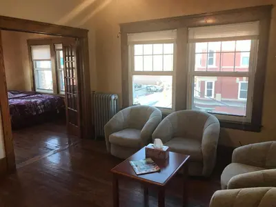 a living room with two chairs and a table at Short Term Rentals Little Italy Cleveland in Cleveland