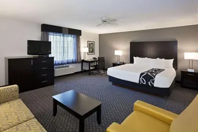 a hotel room with a bed and a couch at La Quinta by Wyndham Cleveland Macedonia in Macedonia